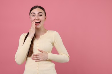 Photo of Beautiful woman laughing on pink background. Space for text