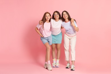 Photo of Portrait of happy friends on pink background