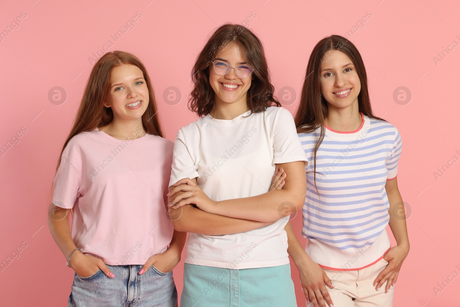 Portrait of happy friends on pink background Photo of Portrait of happy friends on pink background