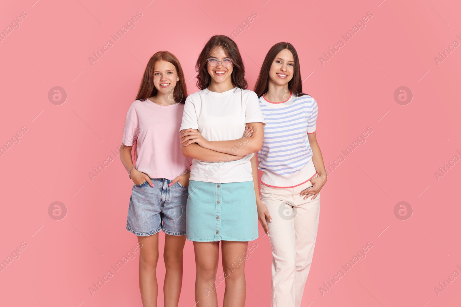Portrait of happy friends on pink background Photo of Portrait of happy friends on pink background