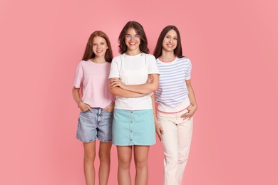 Photo of Portrait of happy friends on pink background
