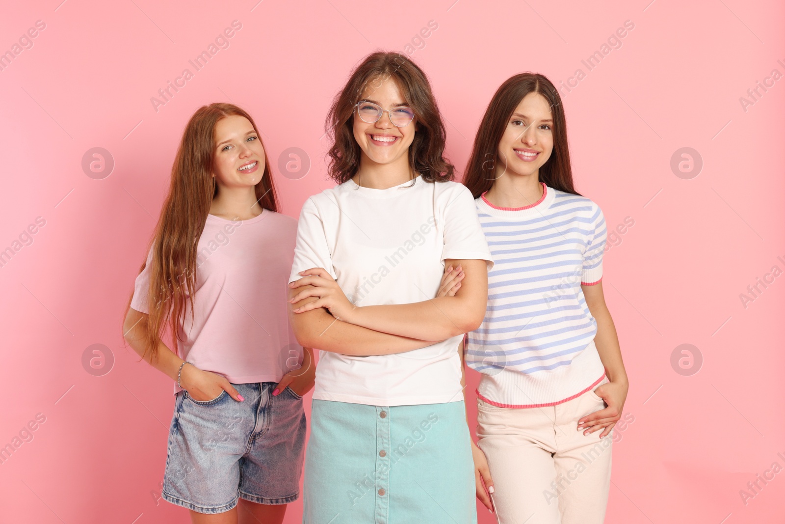 Portrait of happy friends on pink background Photo of Portrait of happy friends on pink background