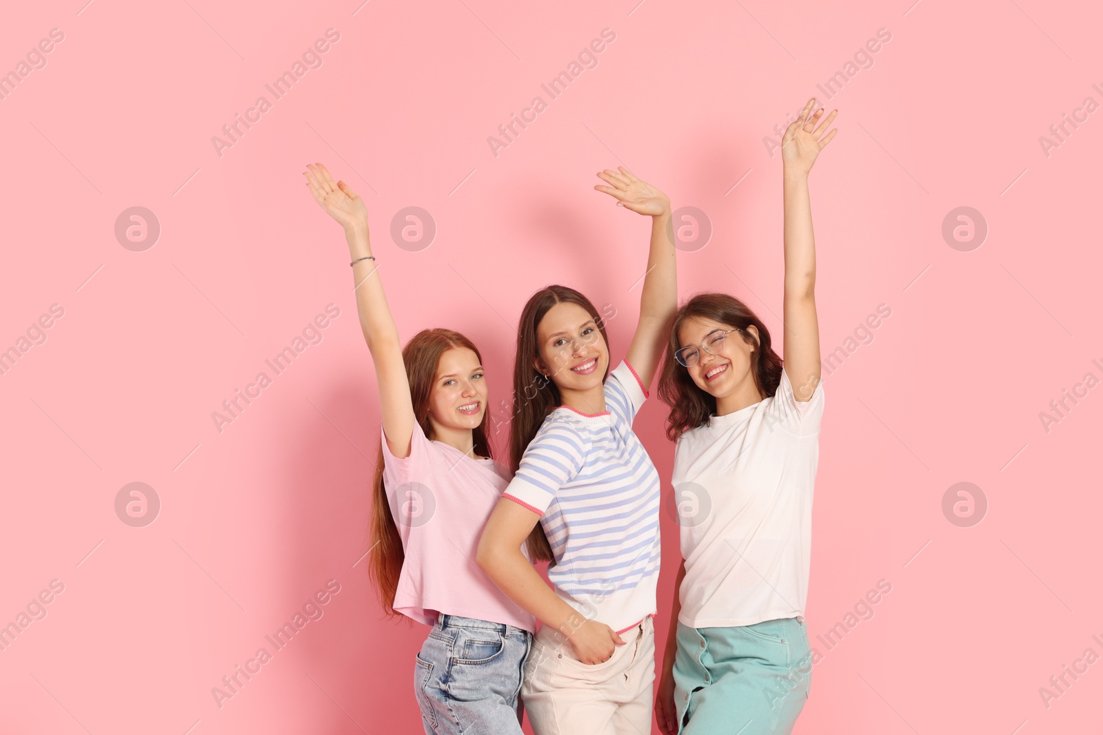 Portrait of happy friends on pink background Photo of Portrait of happy friends on pink background