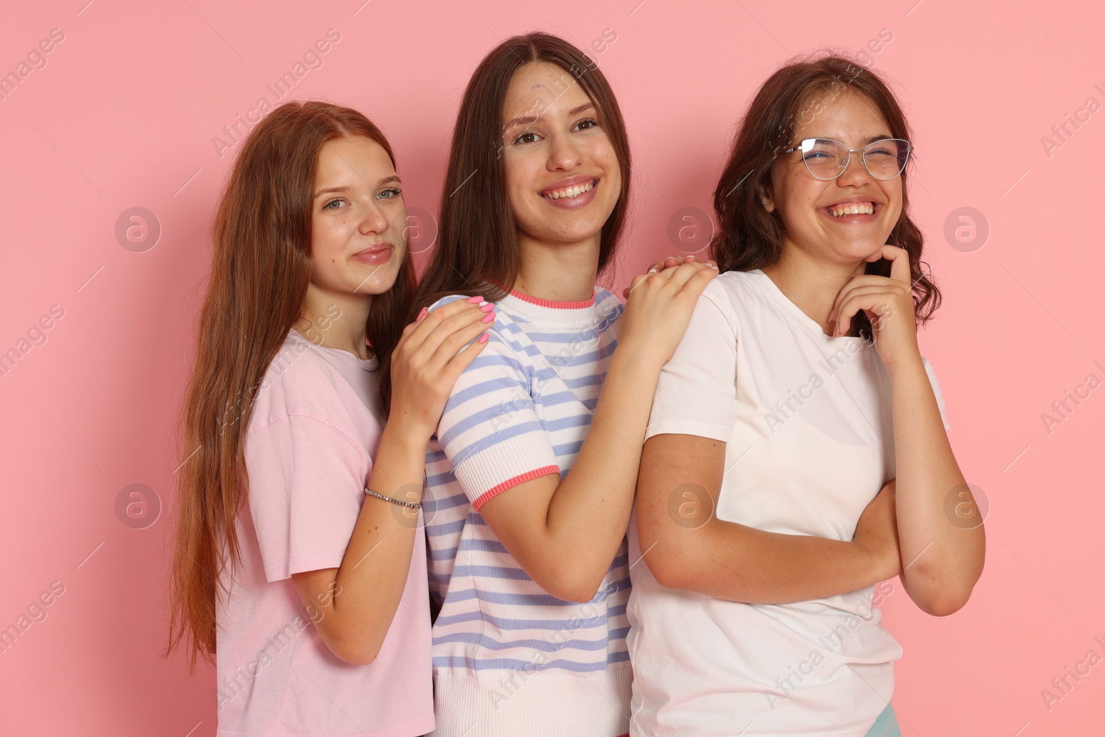 Photo of Portrait of happy friends on pink background