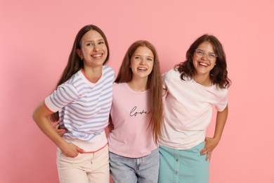 Photo of Portrait of happy friends on pink background