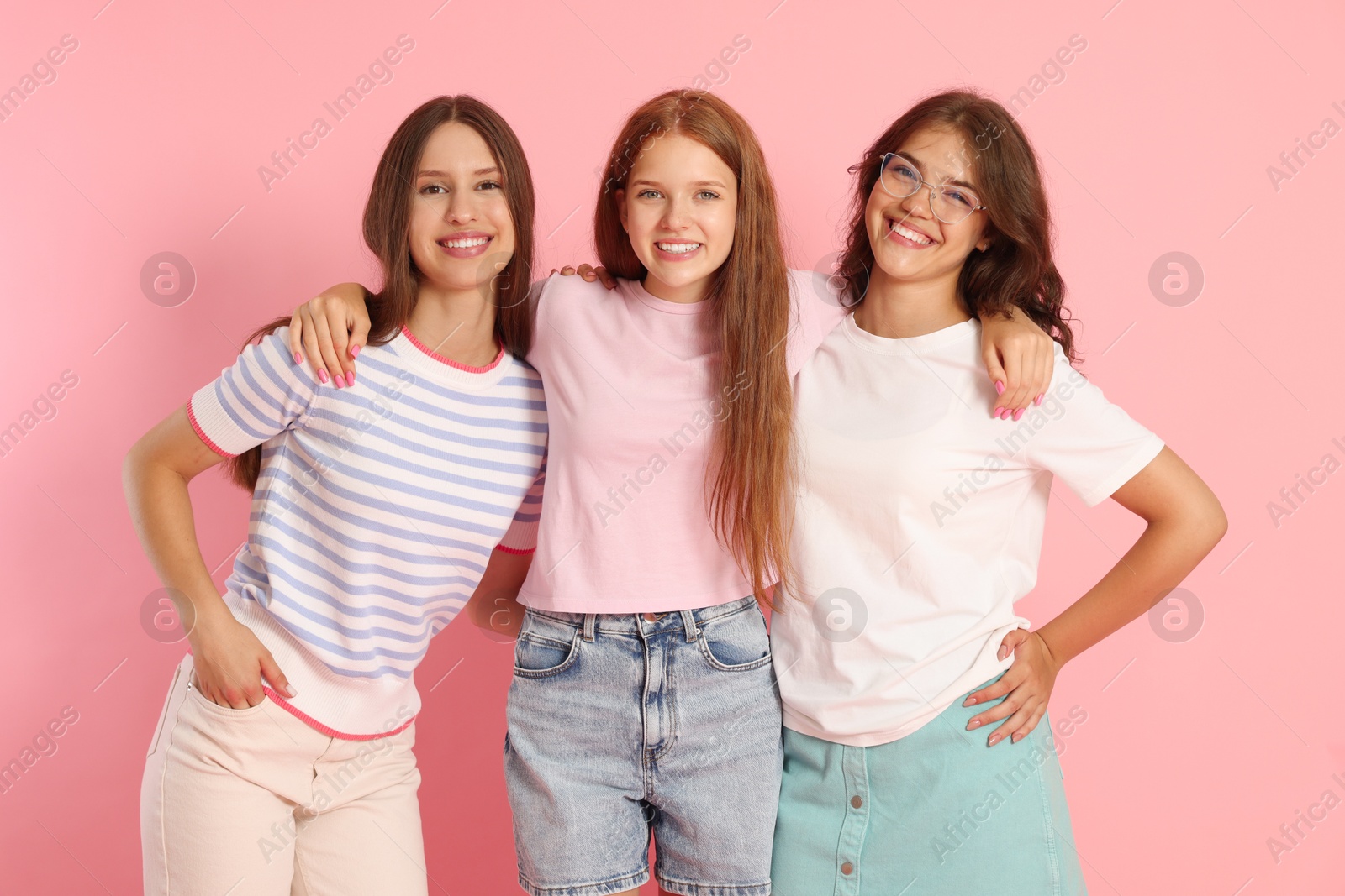 Portrait of happy friends on pink background Photo of Portrait of happy friends on pink background