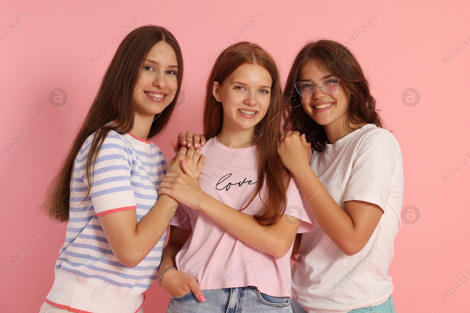 Photo of Portrait of happy friends on pink background