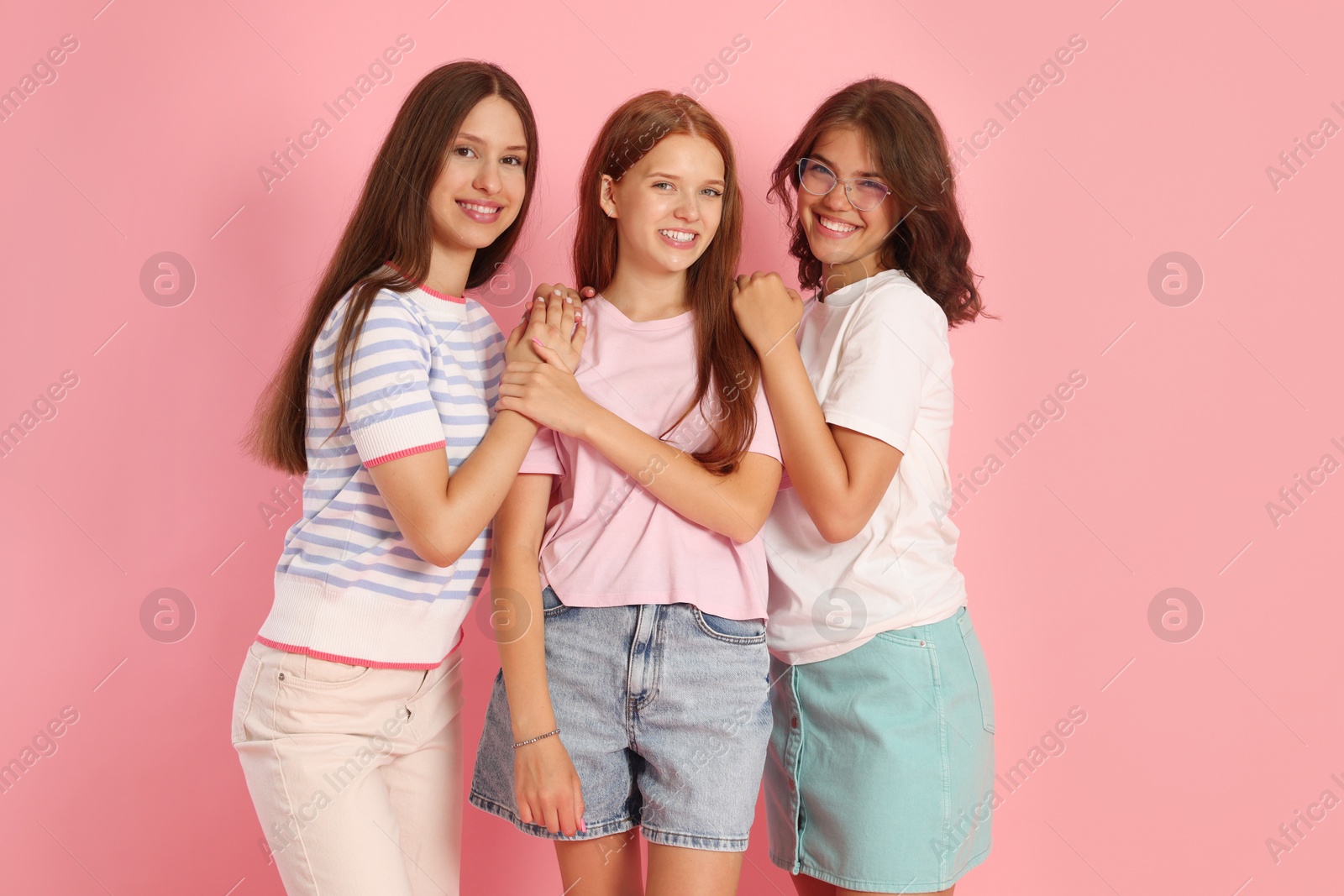 Portrait of happy friends on pink background Photo of Portrait of happy friends on pink background