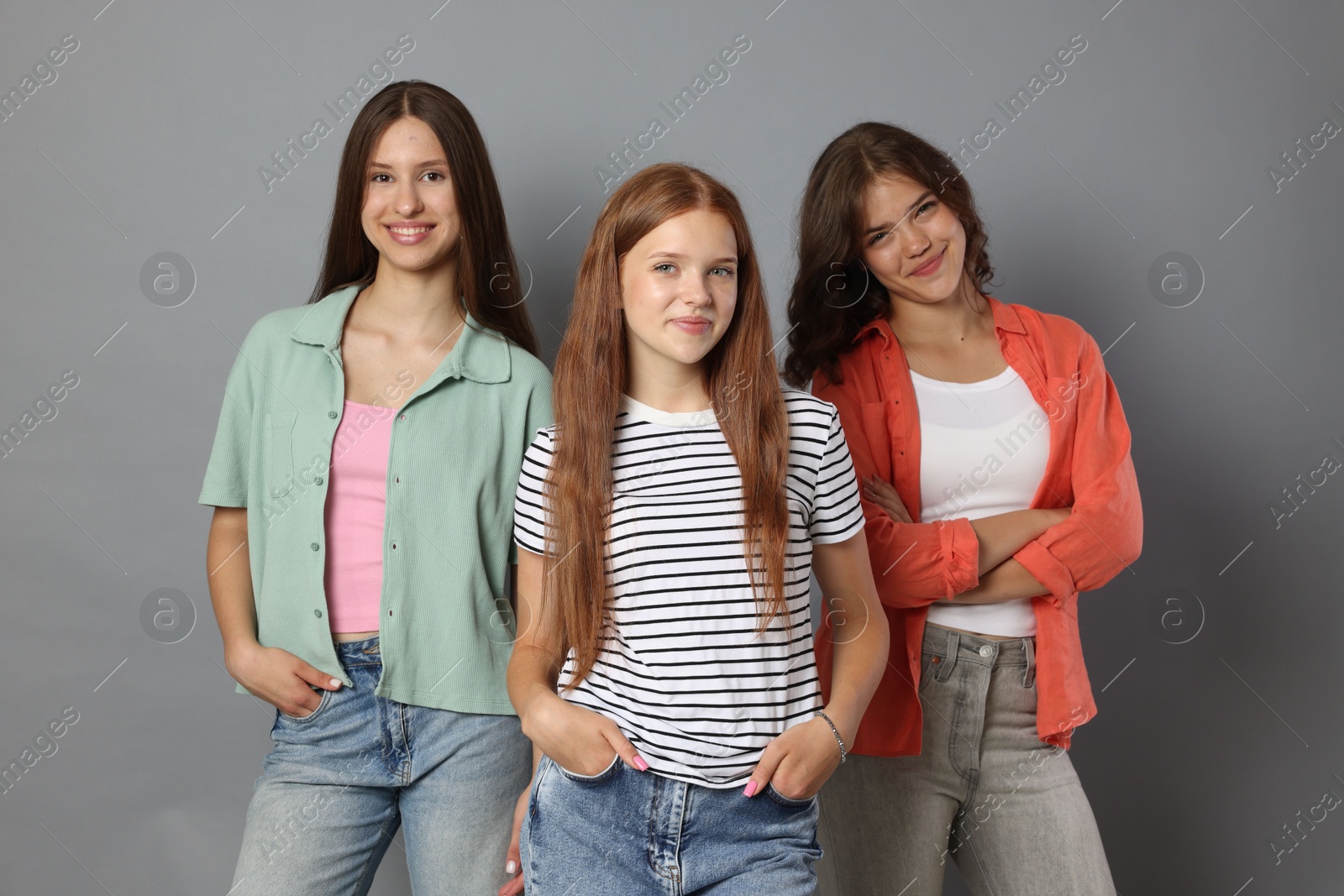 Portrait of happy friends on grey background Photo of Portrait of happy friends on grey background