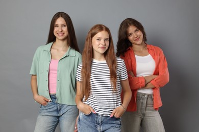 Photo of Portrait of happy friends on grey background