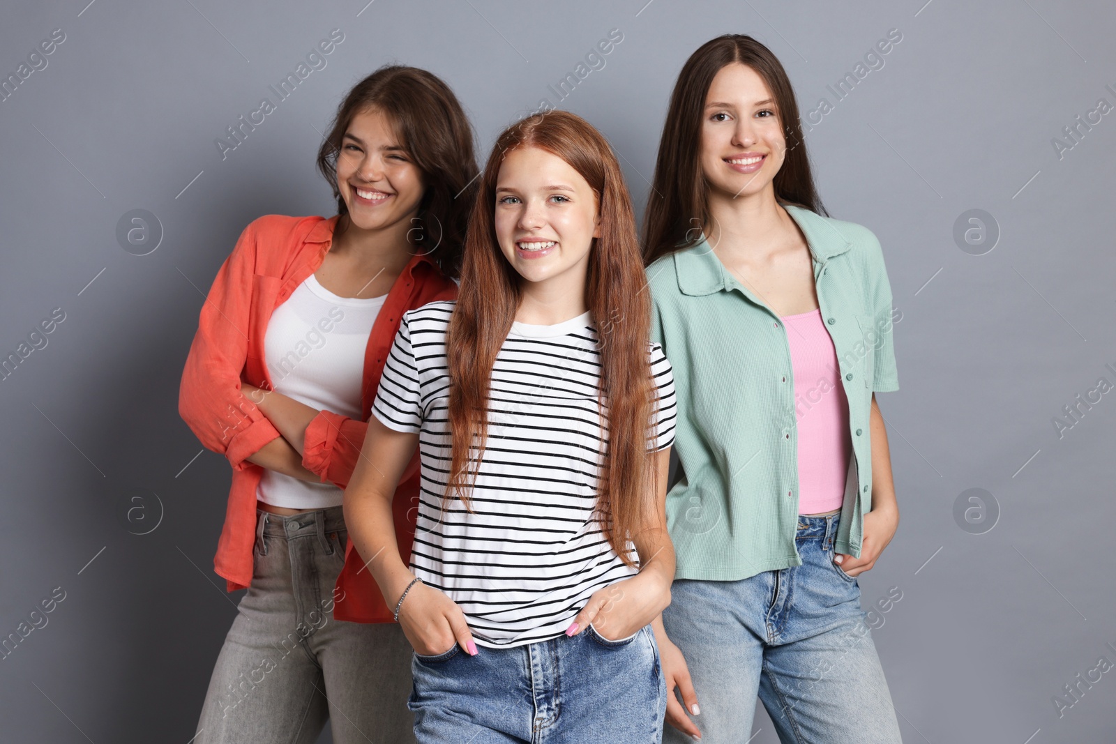 Portrait of happy friends on grey background Photo of Portrait of happy friends on grey background
