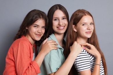 Photo of Portrait of happy friends on grey background