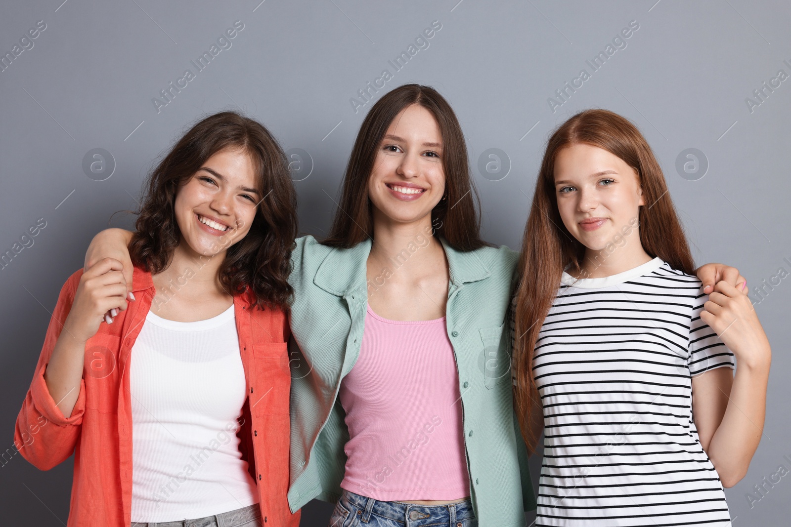 Portrait of happy friends on grey background Photo of Portrait of happy friends on grey background