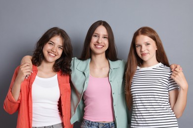 Photo of Portrait of happy friends on grey background