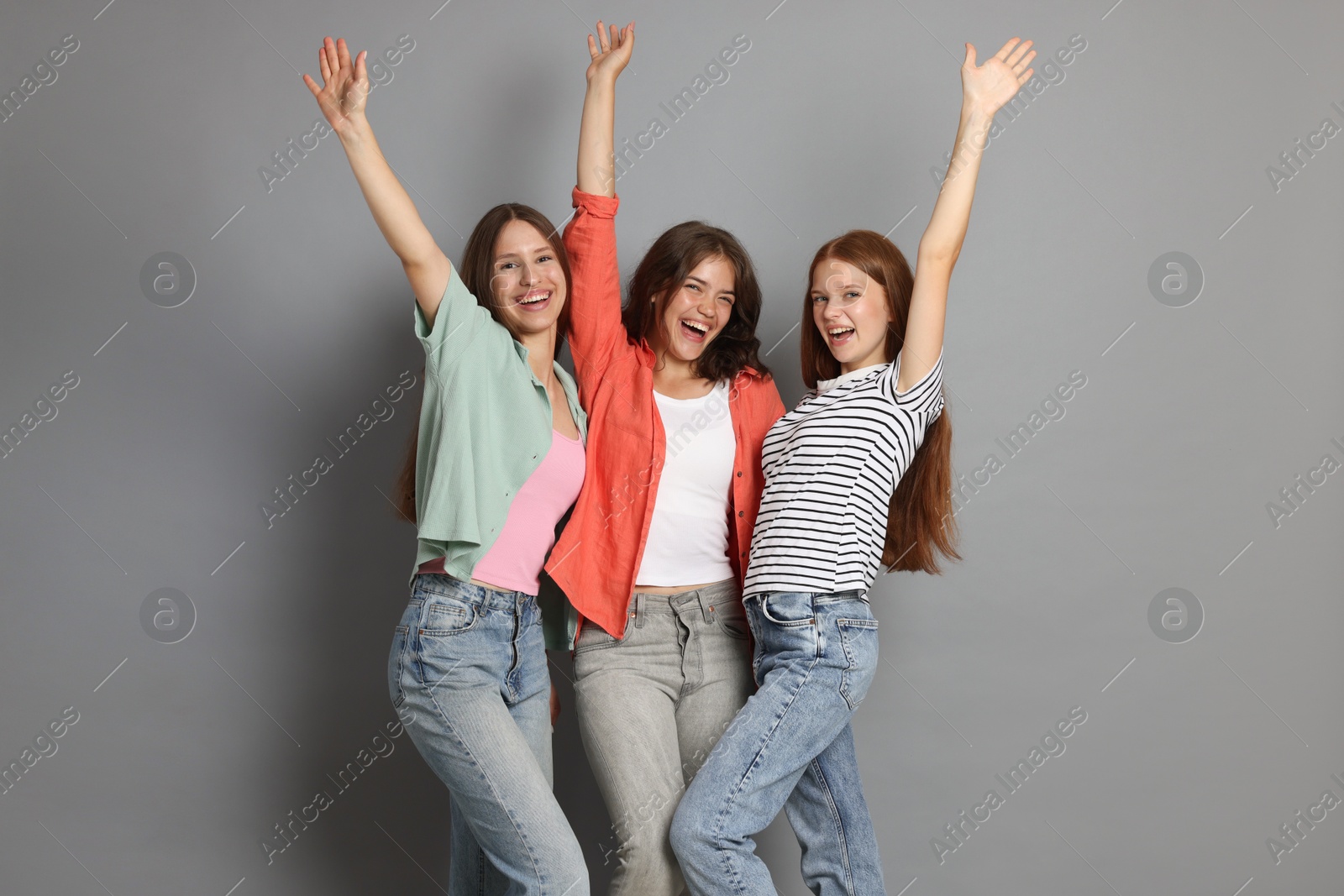 Portrait of happy friends on grey background Photo of Portrait of happy friends on grey background