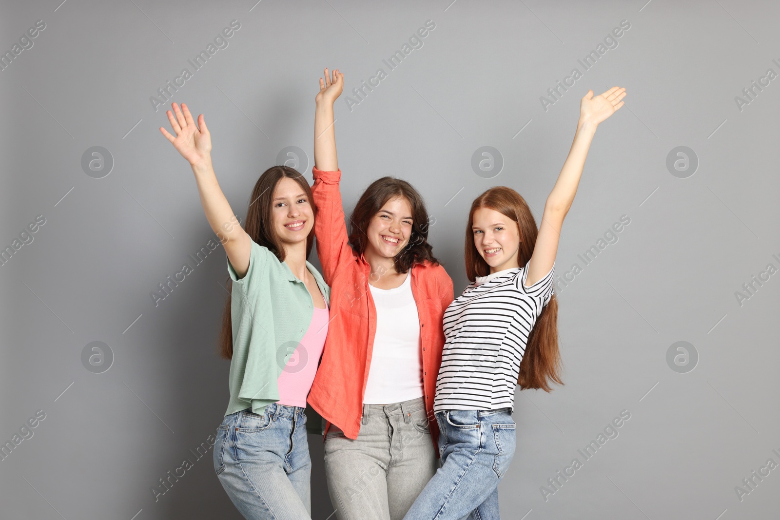 Portrait of happy friends on grey background Photo of Portrait of happy friends on grey background