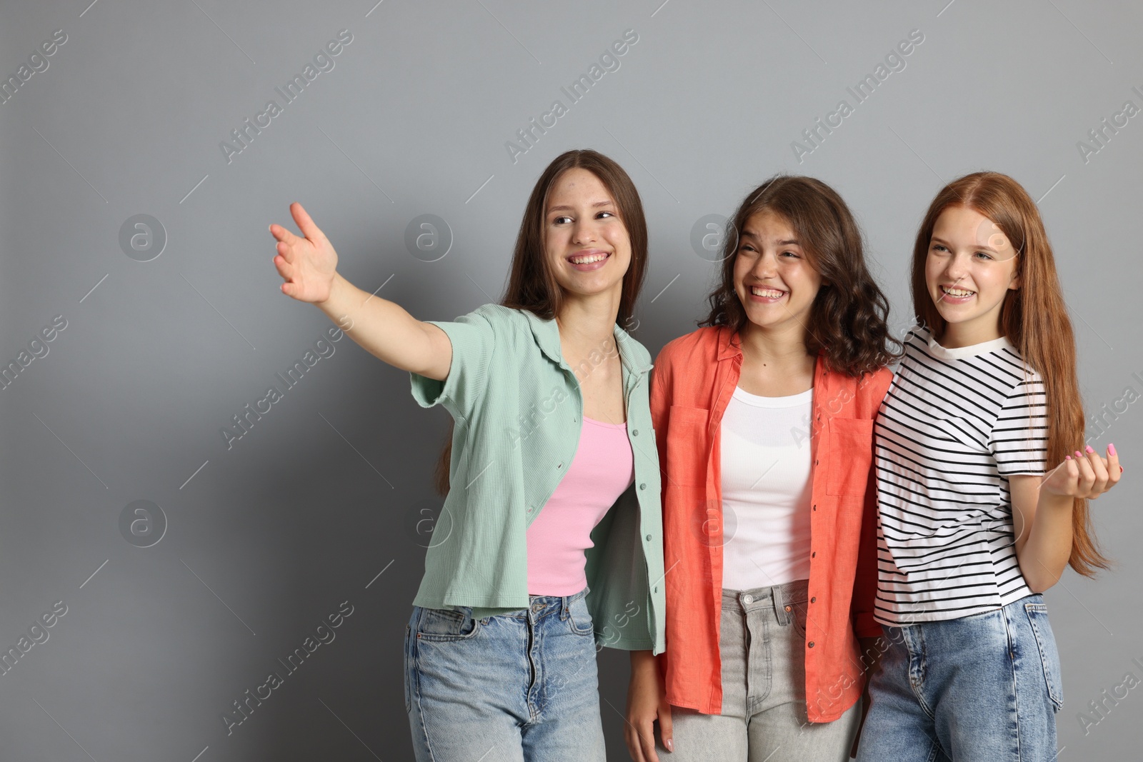 Portrait of happy friends on grey background Photo of Portrait of happy friends on grey background