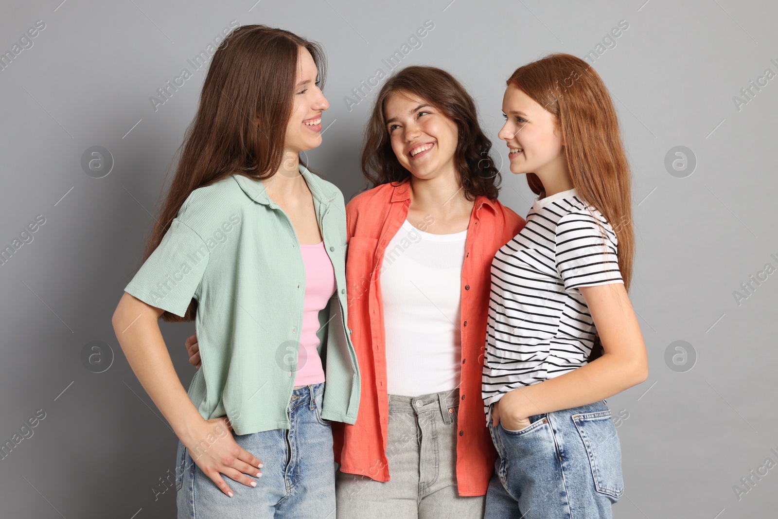 Portrait of happy friends on grey background Photo of Portrait of happy friends on grey background