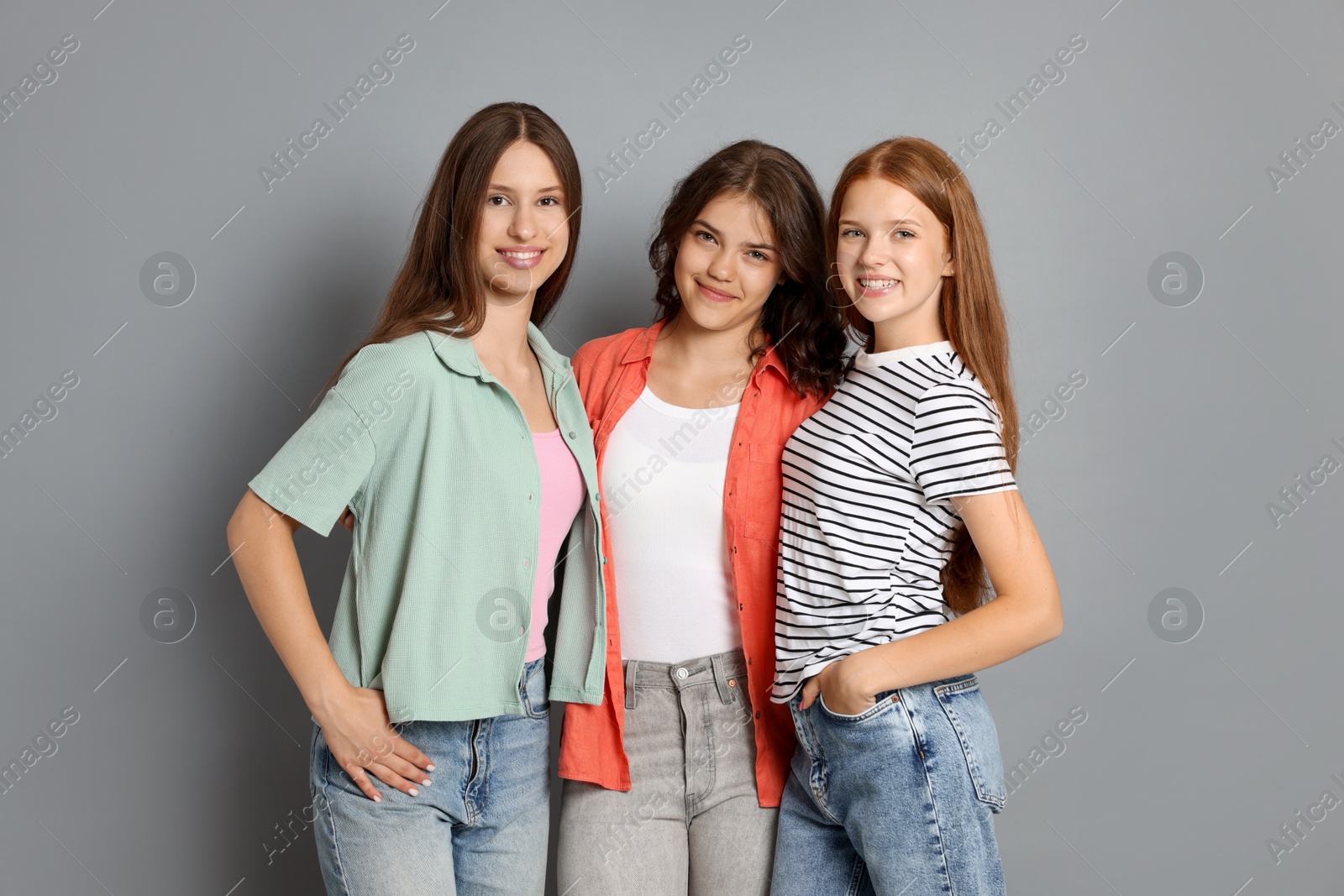 Portrait of happy friends on grey background Photo of Portrait of happy friends on grey background