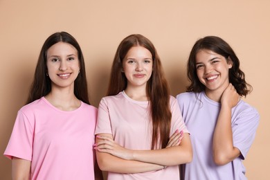 Photo of Portrait of happy friends on beige background