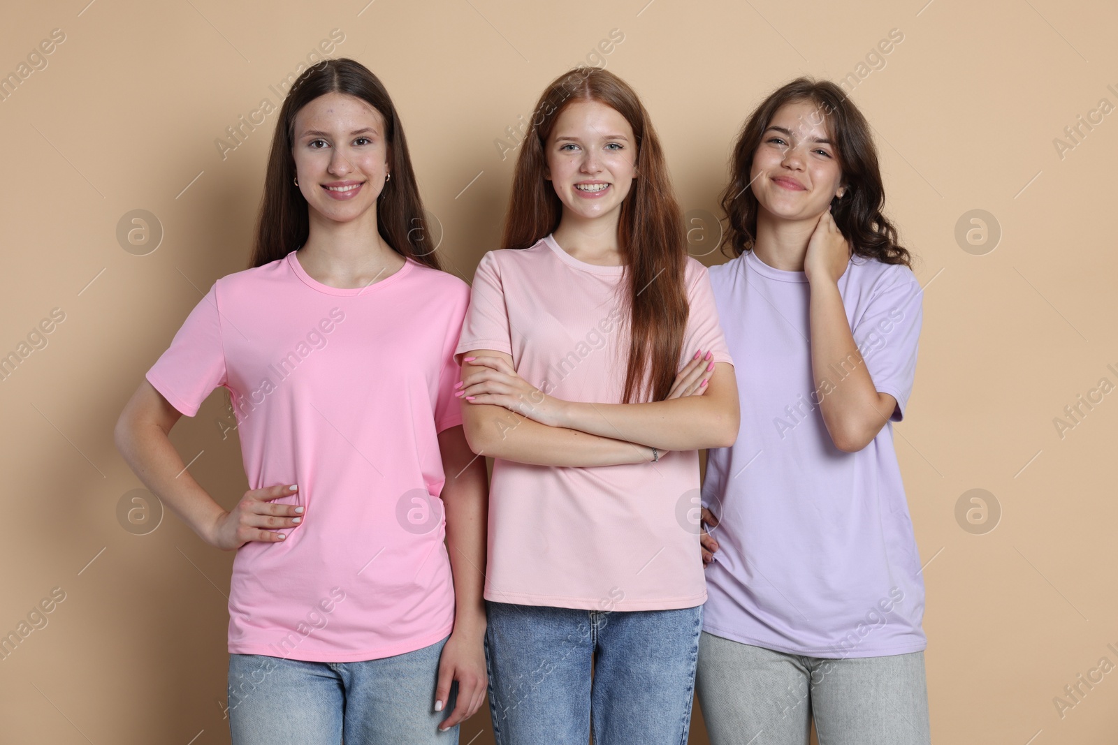Portrait of happy friends on beige background Photo of Portrait of happy friends on beige background