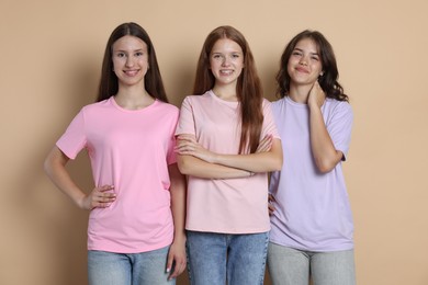 Photo of Portrait of happy friends on beige background