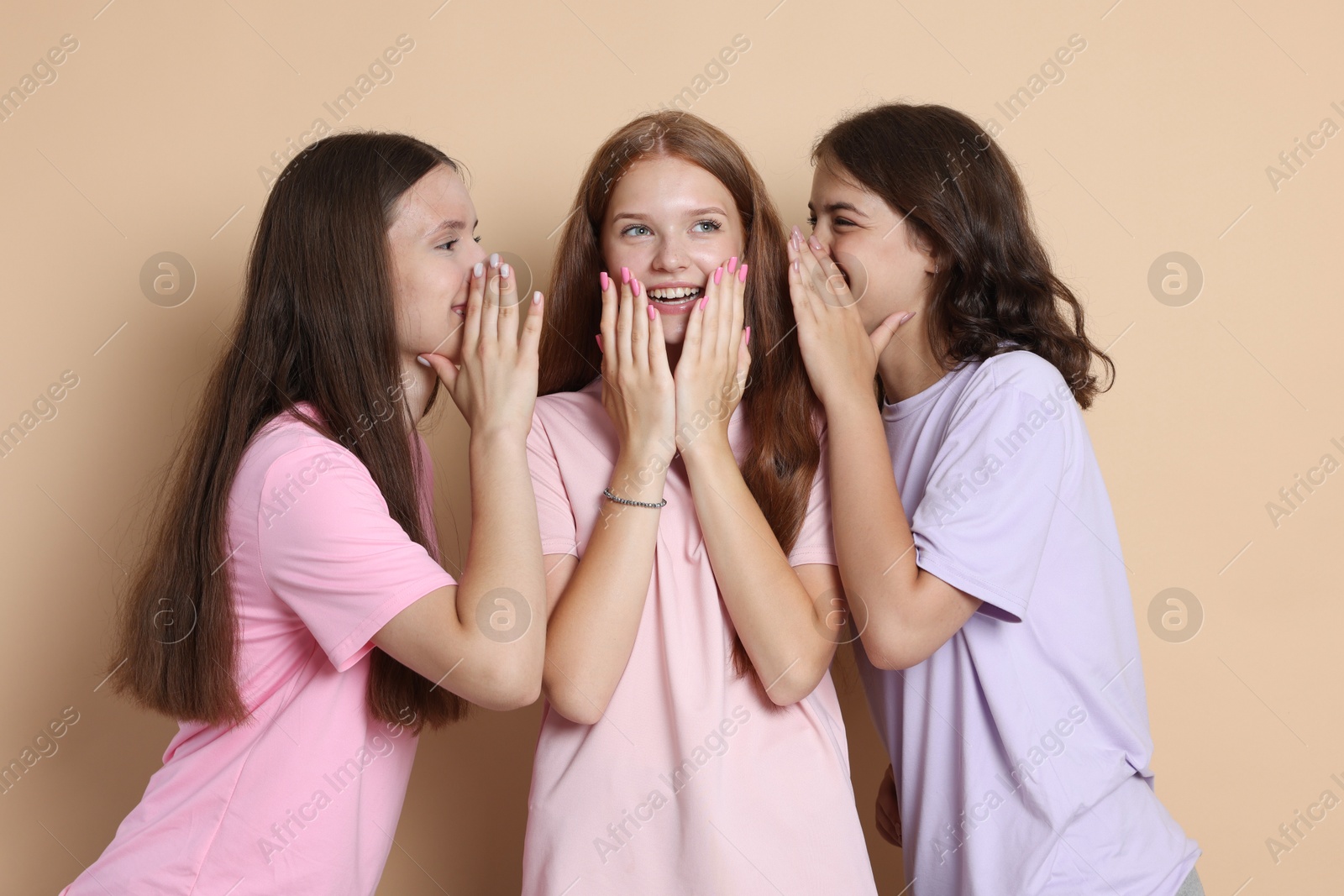 Portrait of happy friends on beige background Photo of Portrait of happy friends on beige background