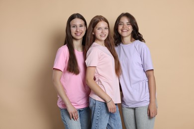 Photo of Portrait of happy friends on beige background