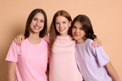 Photo of Portrait of happy friends on beige background