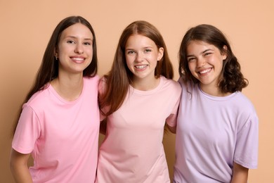 Photo of Portrait of happy friends on beige background