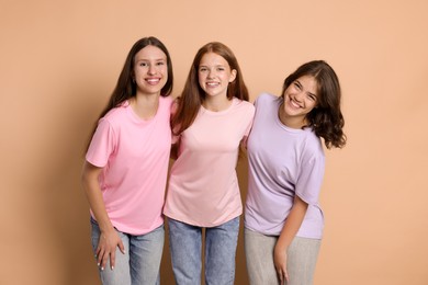 Photo of Portrait of happy friends on beige background