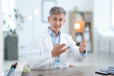 Photo of Telemedicine. Doctor having video call with patient, view from camera