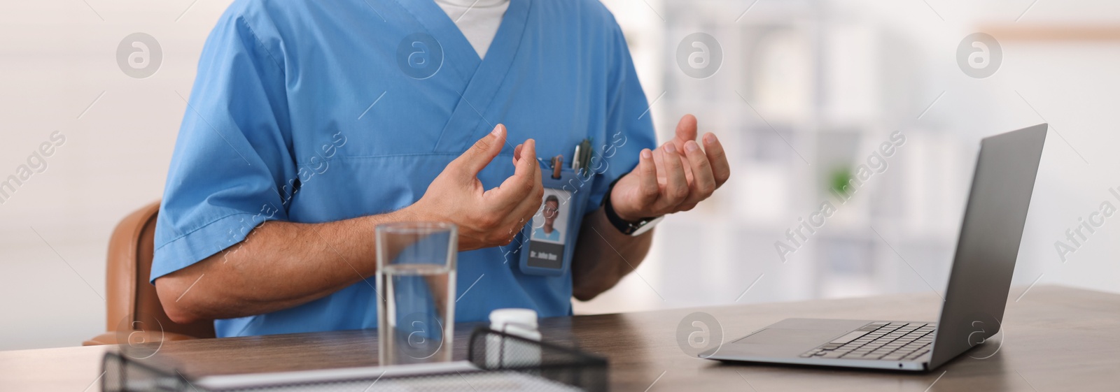Telemedicine. Doctor having video call with patient via laptop indoors, closeup Photo of Telemedicine. Doctor having video call with patient via laptop indoors, closeup