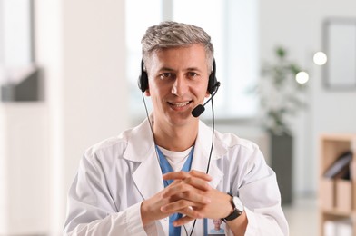 Photo of Telemedicine. Doctor having video call with patient, view from camera