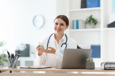 Photo of Telemedicine. Doctor recommending pills to patient during video call via laptop indoors