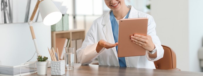 Photo of Telemedicine. Doctor having video call with patient via tablet indoors, closeup