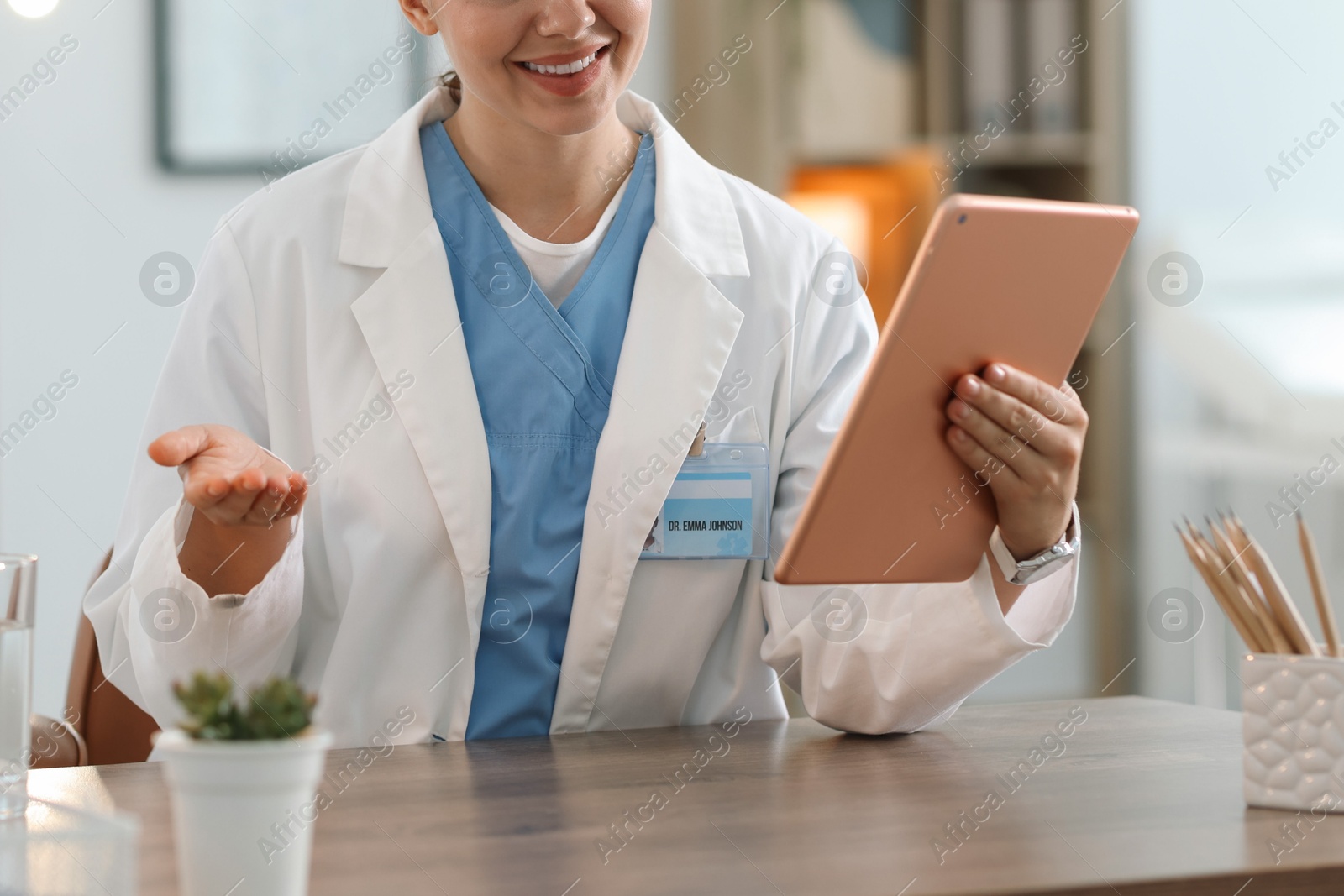 Telemedicine. Doctor having video call with patient via tablet indoors, closeup Photo of Telemedicine. Doctor having video call with patient via tablet indoors, closeup