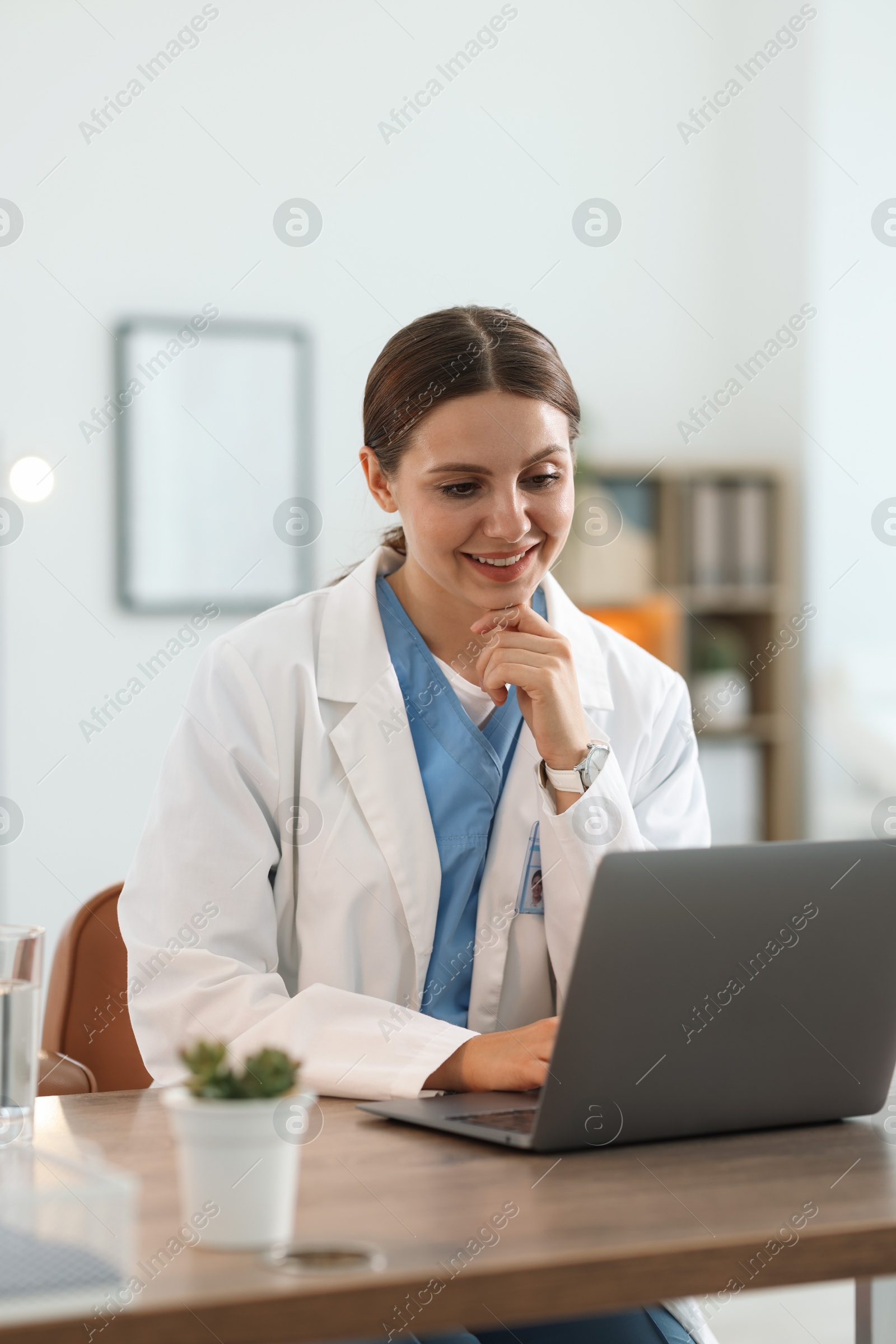 Telemedicine. Doctor having video call with patient via laptop indoors Photo of Telemedicine. Doctor having video call with patient via laptop indoors