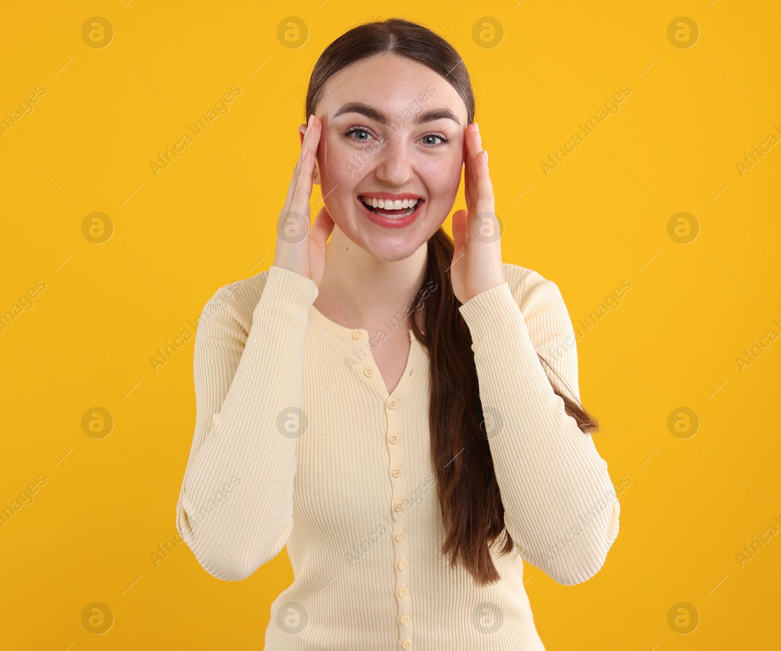 Beautiful woman laughing on yellow background. Positive emotion Photo of Beautiful woman laughing on yellow background. Positive emotion