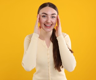 Photo of Beautiful woman laughing on yellow background. Positive emotion