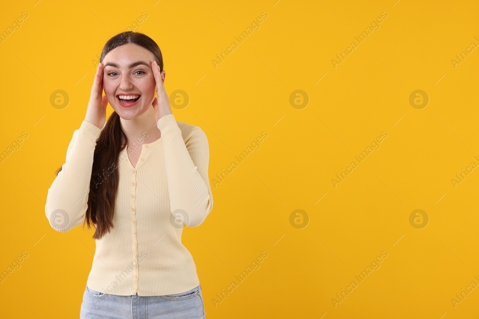 Beautiful woman laughing on yellow background. Space for text Photo of Beautiful woman laughing on yellow background. Space for text