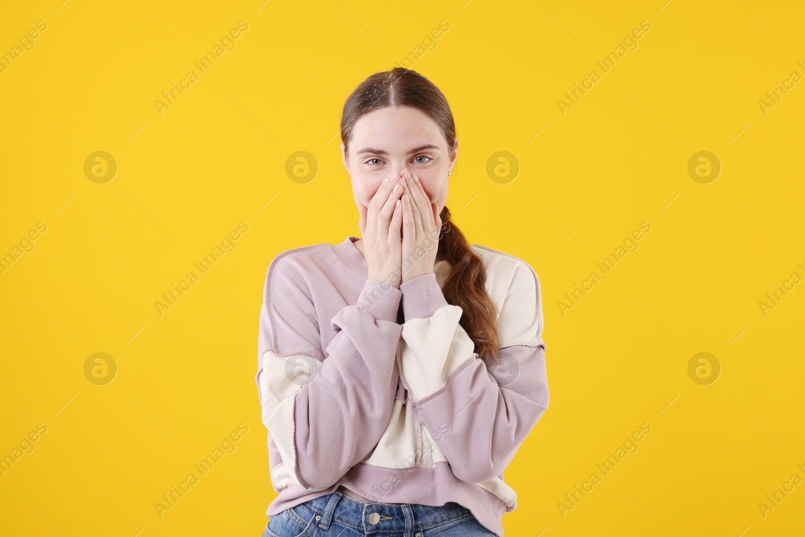 Beautiful woman laughing on yellow background. Positive emotion Photo of Beautiful woman laughing on yellow background. Positive emotion