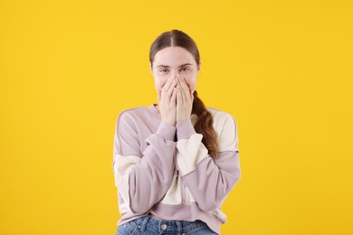 Photo of Beautiful woman laughing on yellow background. Positive emotion