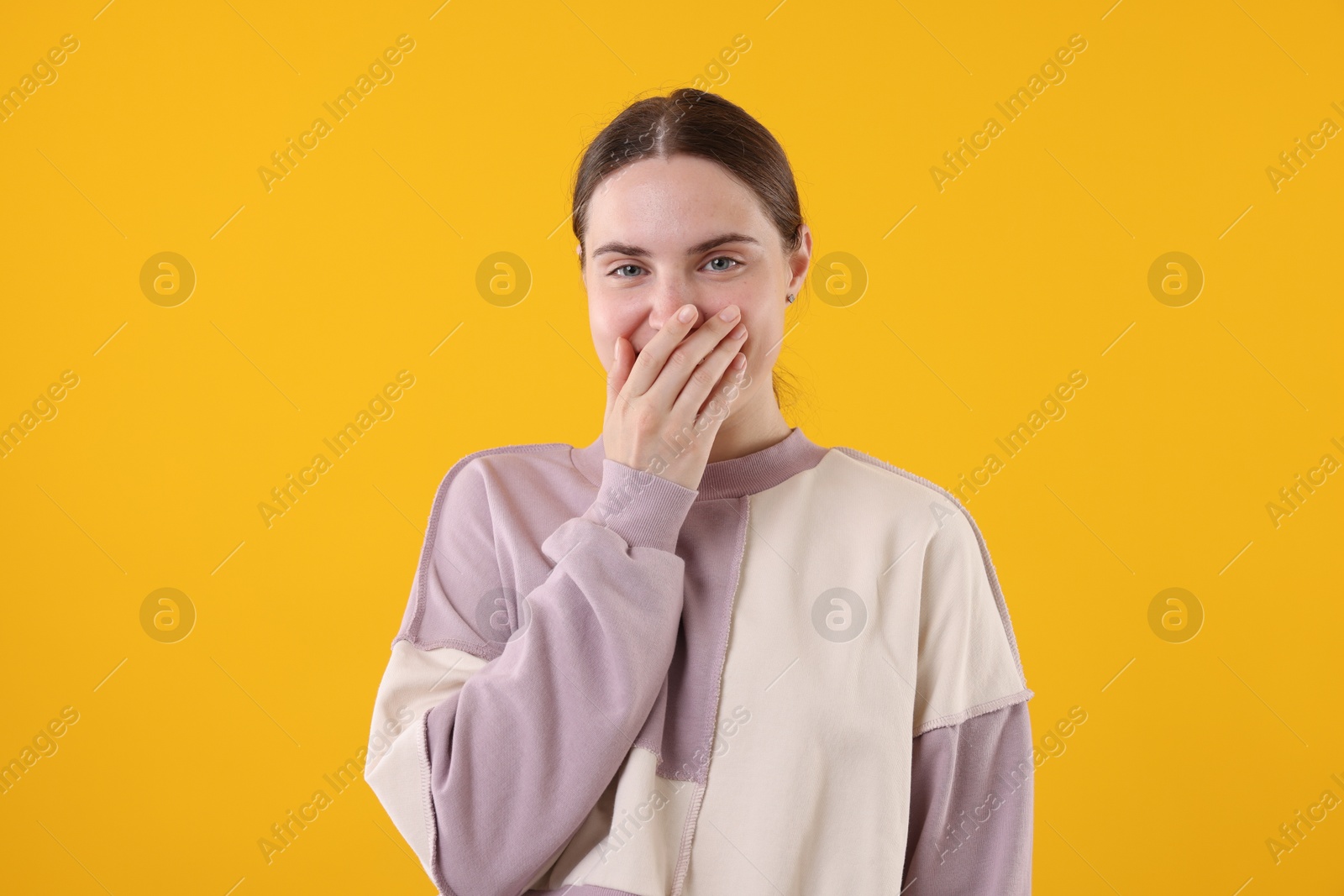 Beautiful woman laughing on yellow background. Positive emotion Photo of Beautiful woman laughing on yellow background. Positive emotion