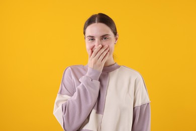 Photo of Beautiful woman laughing on yellow background. Positive emotion