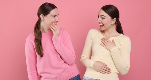 Photo of Beautiful women laughing on pink background. Positive emotion