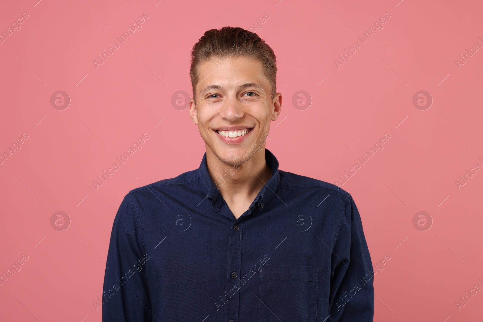 Handsome man laughing on pink background. Positive emotion Photo of Handsome man laughing on pink background. Positive emotion