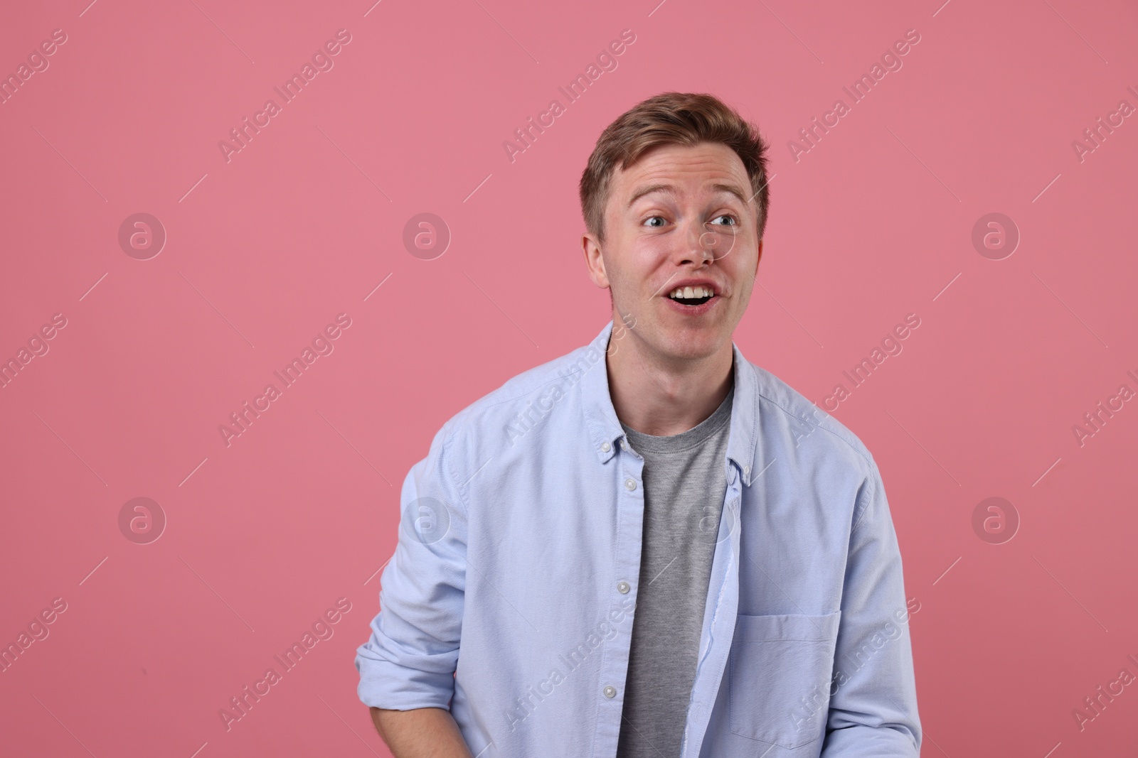 Emotional man on pink background. Positive emotion Photo of Emotional man on pink background. Positive emotion