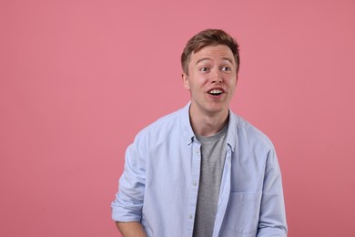 Photo of Emotional man on pink background. Positive emotion