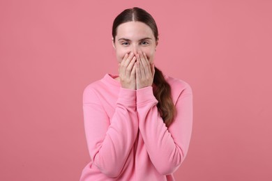 Photo of Beautiful woman laughing on pink background. Positive emotion